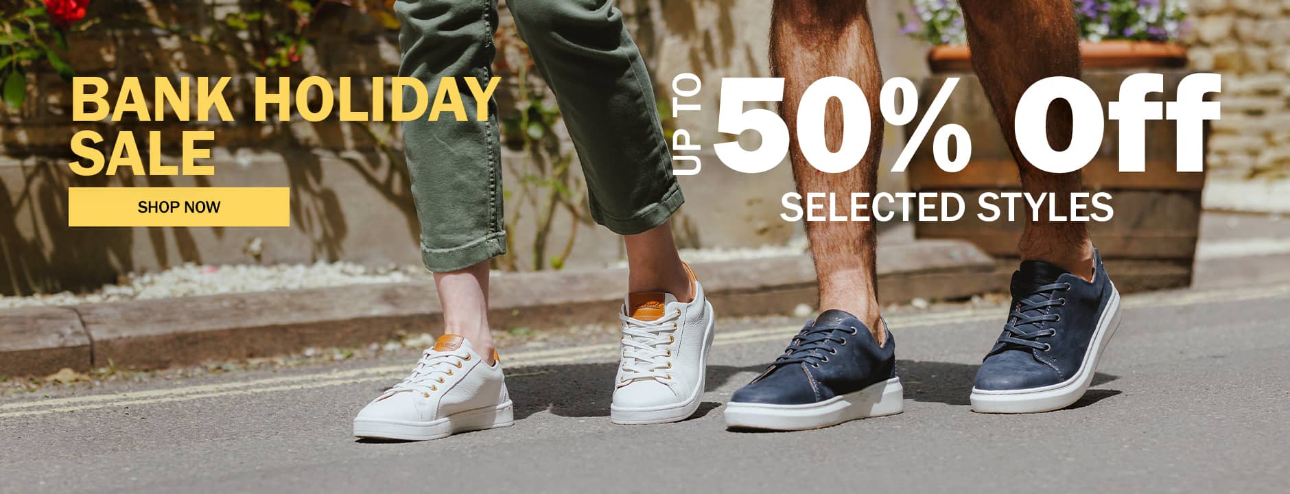 Banner promoting Cotswold's Bank holiday sale - Up to 50% Off selected styles. Text appears on an image of a couple wearing Cotswold shoes walking together on a sunny sidewalk.  Click banner to shop now.