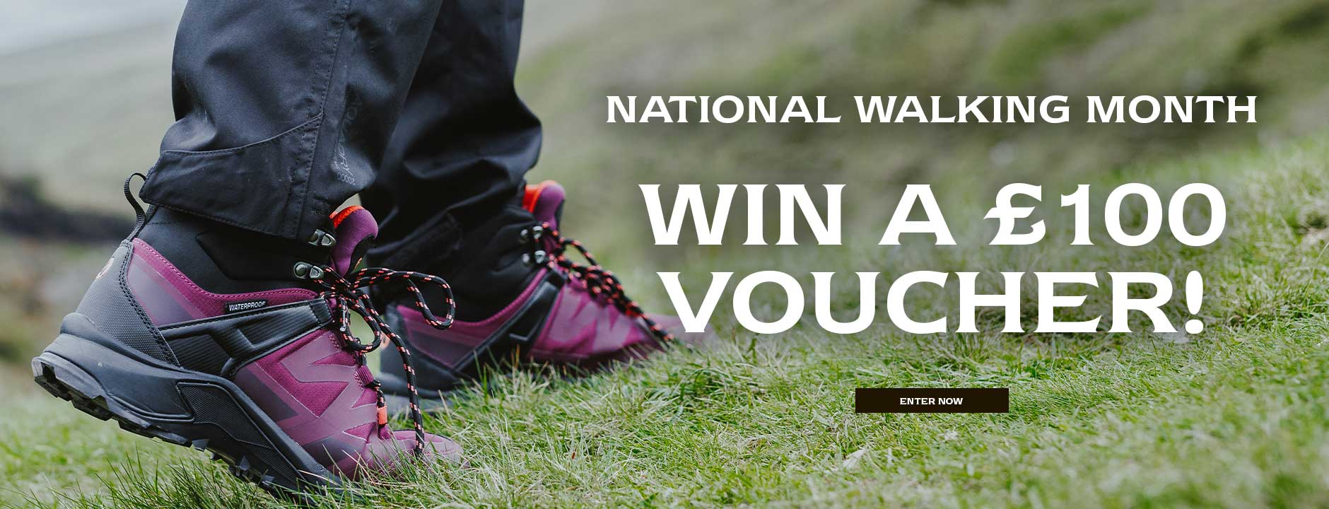 Close up image of a person wearing a pair of burgundy Cotswold Horton Hiking Boots. Text reads 'NATIONAL WALKING MONTH. WIN A £100 VOUCHER. ENTER NOW'